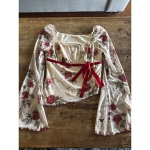 Sheer Floral Asymmetrical blouse with bell sleeves lettuce trim sleeves.